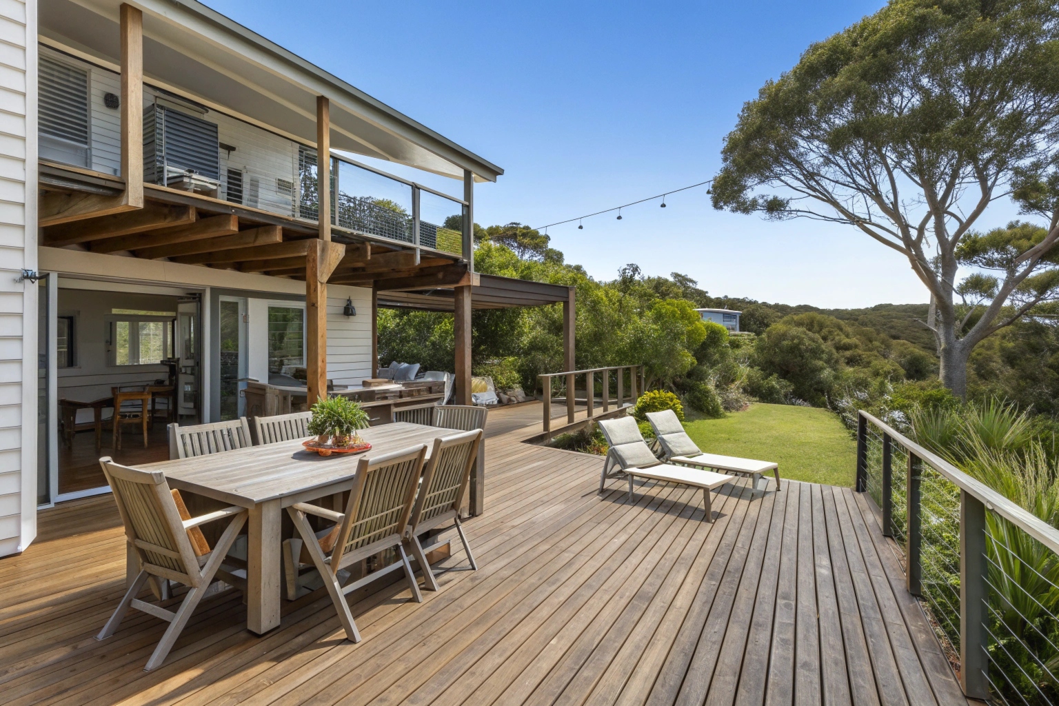 Wraparound deck extension creating separate outdoor living zones